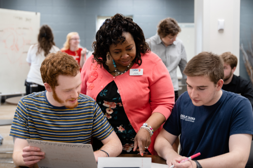 faculty helping two students